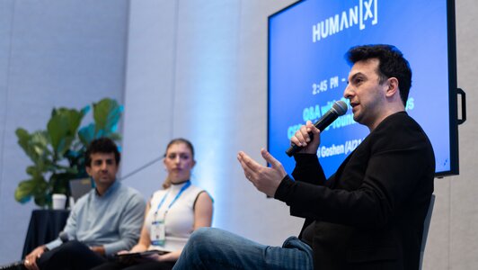 HumanX attendees smile and cheers one another at an afterparty event at the conference