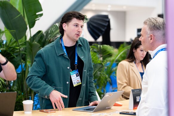 An exhibitor speaks to an attendee on the showfloor at HumanX 2026 San Francisco