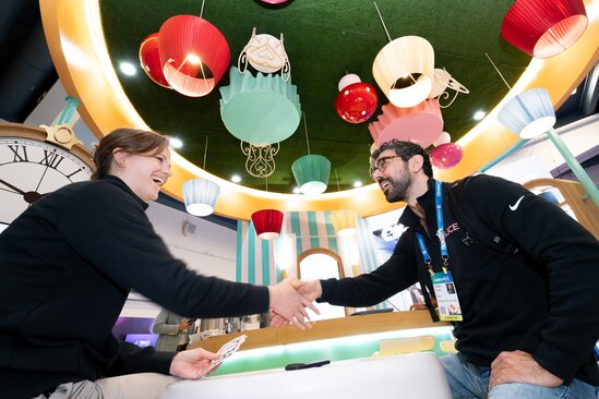 An exhibitor shakes the hand of an attendee at their booth on the showfloor at HumanX San Francisco in 2026
