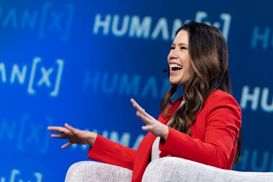 A moderator laughs on stage at HumanX San Francisco 2026