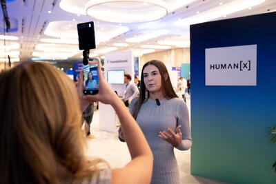 A reporter is interviewed on the show floor at humanx