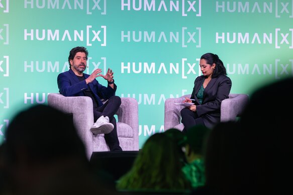 Audience members smile during a main stage session at HumanX San Francisco 2026