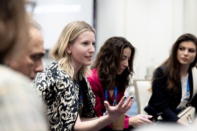 Attendees sit in a circle in an interactive session at HumanX 2025