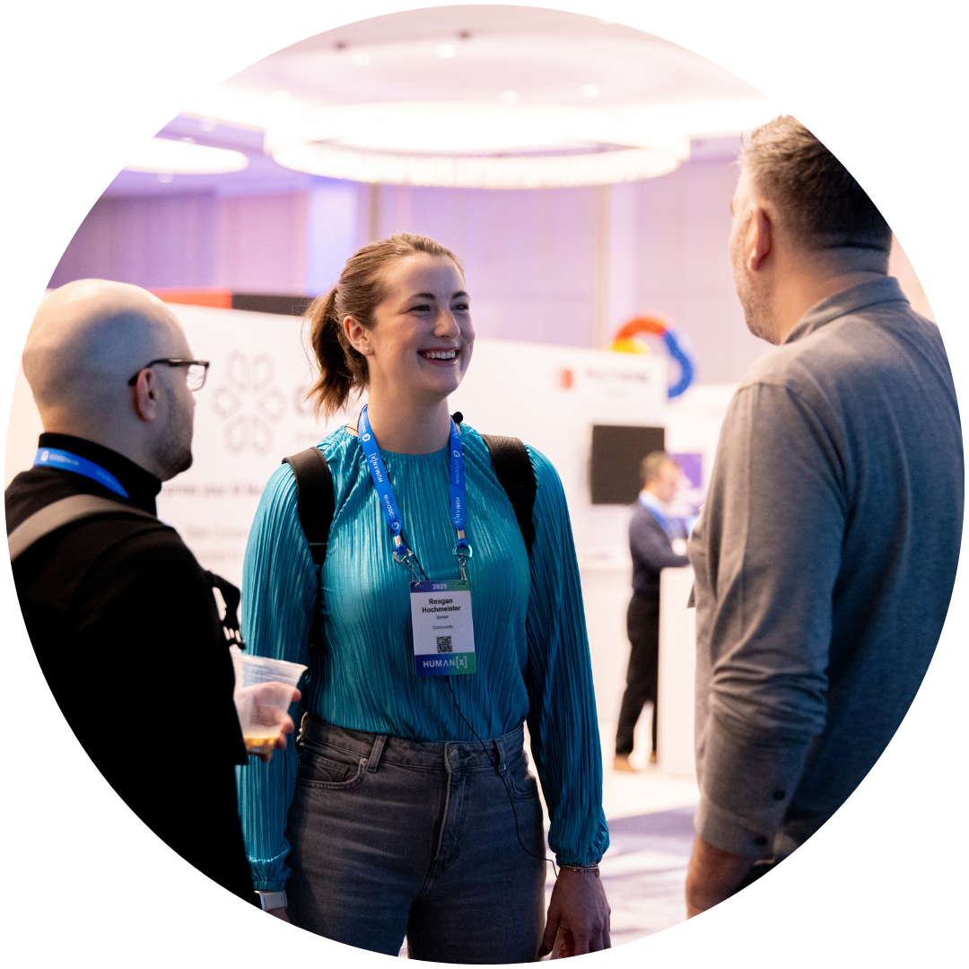 HumanX 2026 attendees chatting on the exhibit hall floor