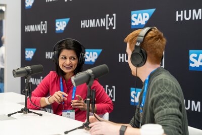 podcasters record an interview in the podcast booth on the showfloor at humanx