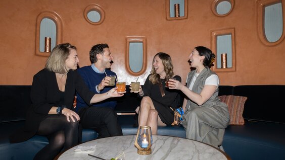 A woman addresses two people at a business meeting.