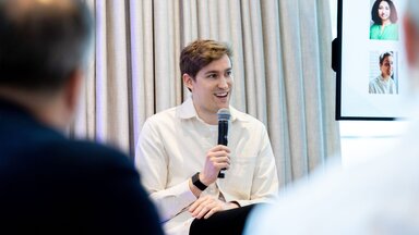 A speaker addresses the crowd at a breakfast meeting at HumanX 2025