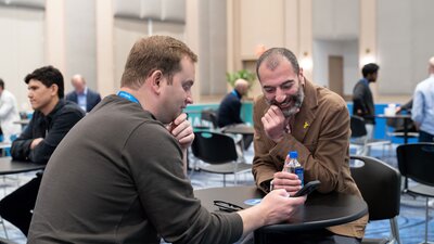 A man makes his pitch to a panel of judges at the 2025 HumanX startup stage