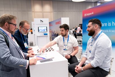 Attendees network at a booth on the showfloor at HumanX 2025